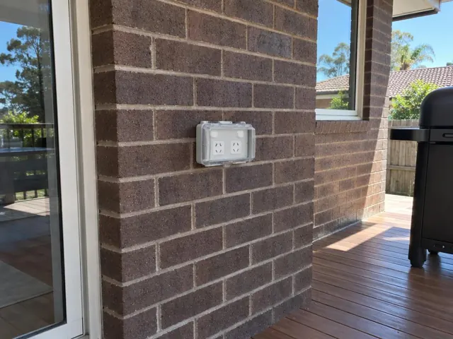 Outdoor double power point on a brick wall beside a timber deck in Dee Why